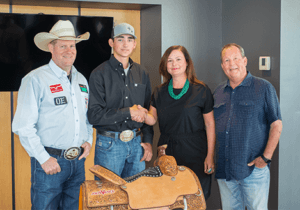 Megan Vance , VP of John Vance Auto Group, standing beside rodeo champion Clint Graves