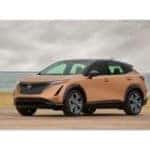 New 2023 Nissan Ariya SUV parked in front of beach