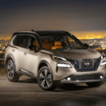 New Nissan Rogue Platinum SUV with city lights in background