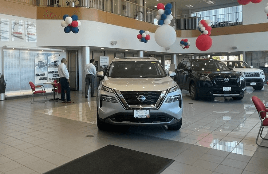 Silver Nissan Rogue in showroom at Kelly Nissan of Woburn