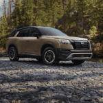 Beige Nissan Pathfinder Rock Creek Edition parked in front of river