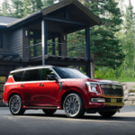 Red 2025 Nissan Armada Platinum Reserve in front of home parked in driveway
