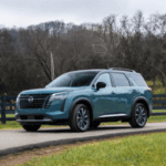 Nissan Pathfinder driving down street