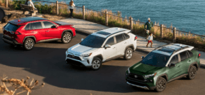 New 2024 Toyota RAV4 Near Covington, LA shown in Ruby Flare Pearl, Ice Cap, and Army Green with Ice Edge roof.
