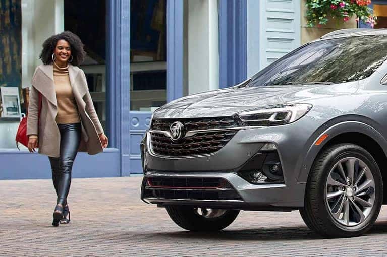Woman walking next to 2023 Encore GX