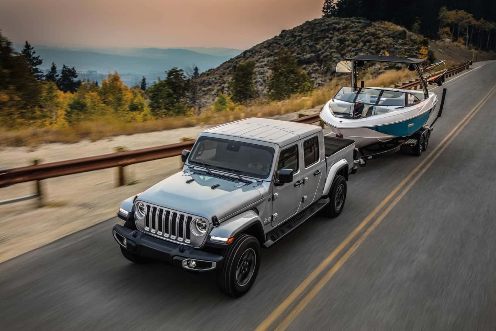 Jeep Gladiator towing boat on the highway