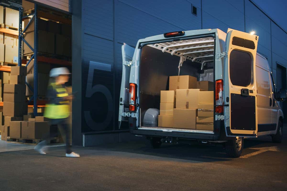 people unloading a cargo van