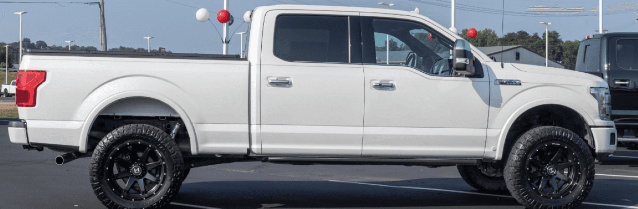 A lineup of used pickup trucks for sale at T's Auto & Truck Sales in Omaha.