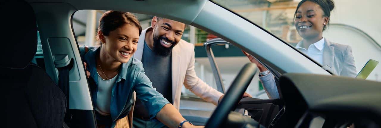 Friendly staff at T's Auto & Truck Sales assisting customers in finding the perfect used car in Omaha, NE.