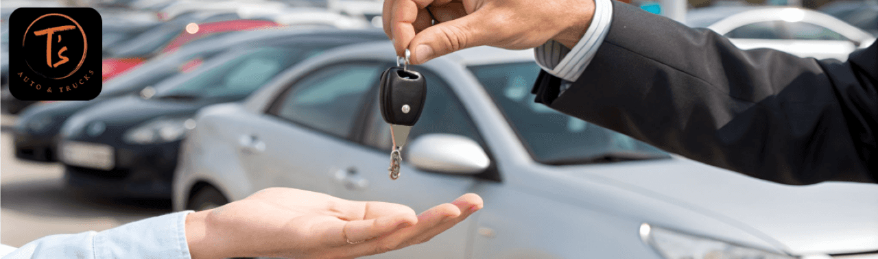 Customer receiving keys for a quality pre-owned vehicle purchased from T's Auto & Truck Sales.