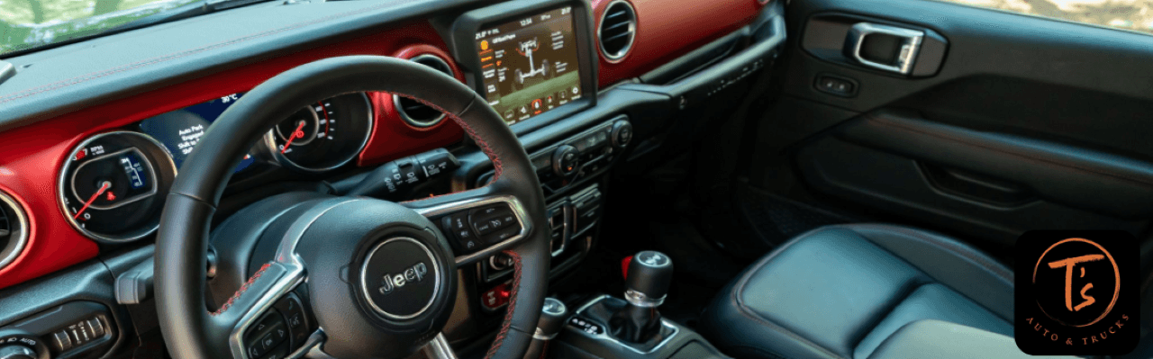 Interior view of a Jeep Wrangler Rubicon, showcasing the touchscreen display, 4x4 gear selector, and durable seating – perfect for Douglas County drivers.