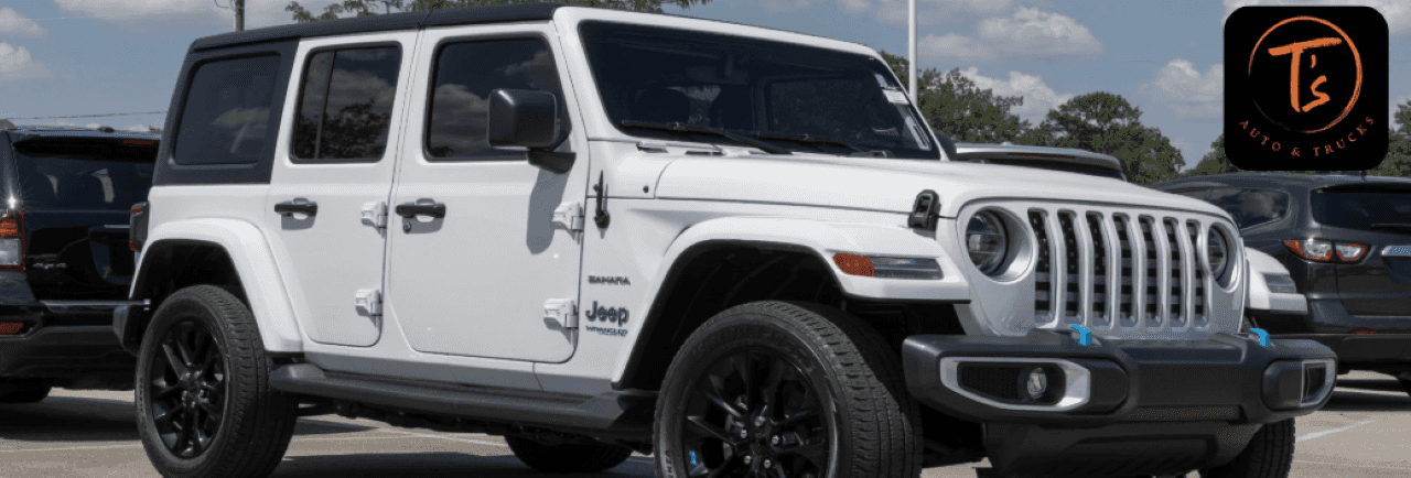 A lifted used Jeep Wrangler with off-road tires parked at T’s Auto and Truck Sales in Omaha, NE – ready for rugged terrain or city streets.
