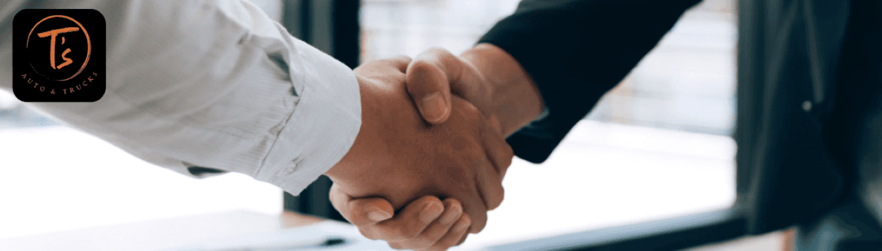 Sales associate shaking hands with a customer after reviewing Kelley Blue Book trade-in value at the Omaha dealership