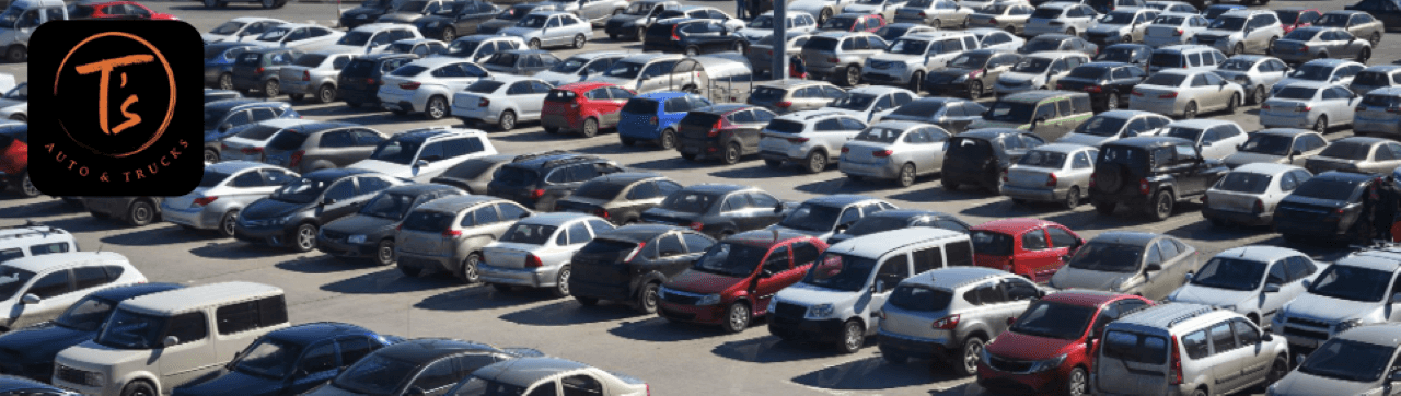 Selection of used cars and trucks parked at T’s Auto & Truck Sales dealership in Omaha, NE
